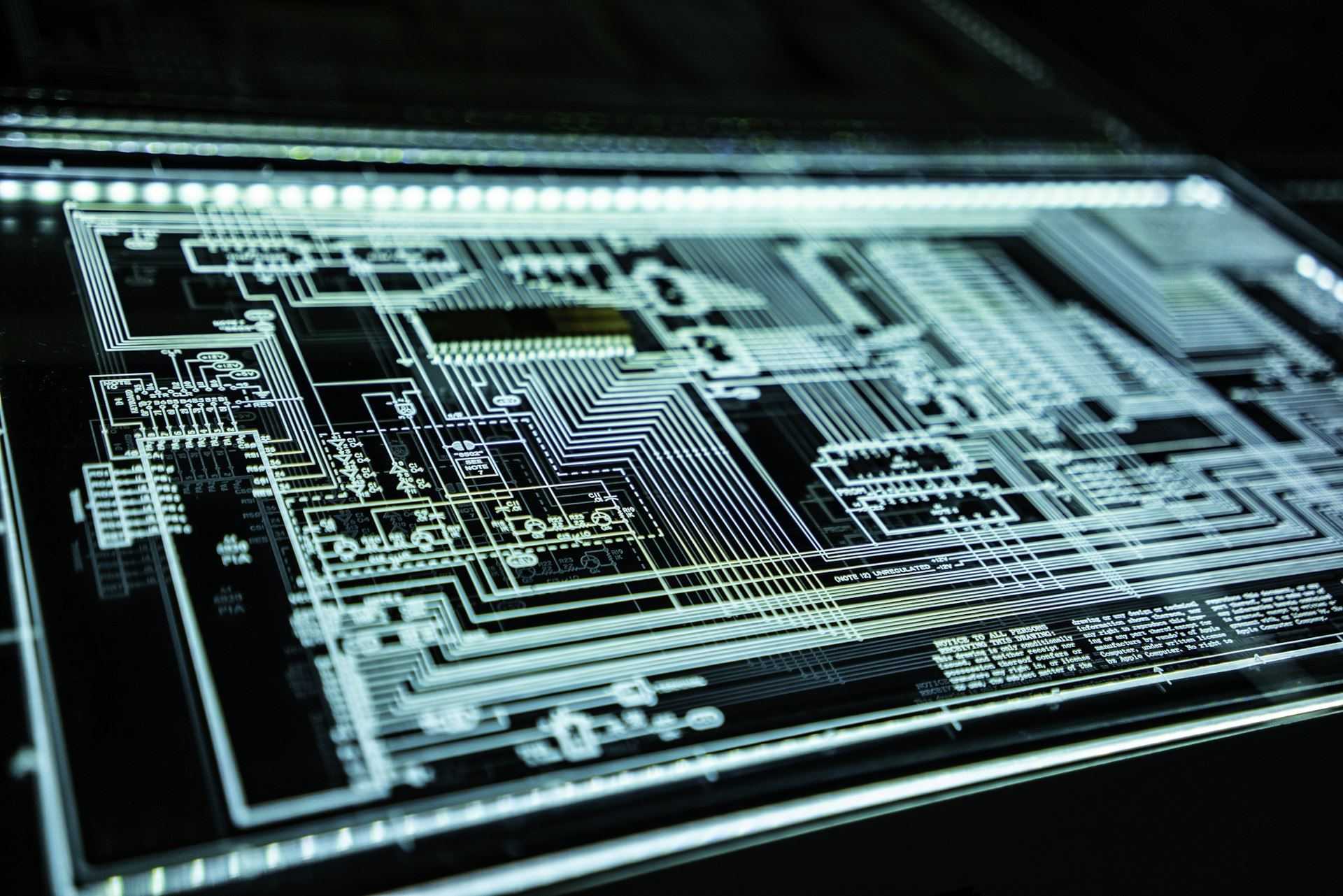 Backlit circuit board schematic with labeled processor blocks