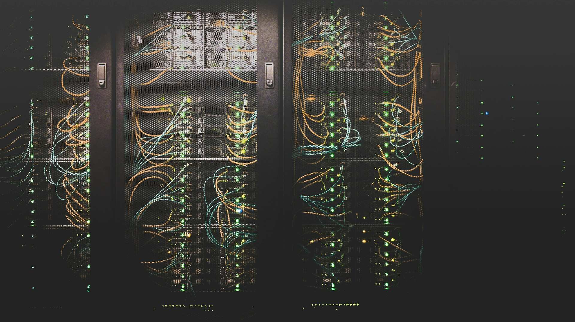 Server racks and network cables in a cooled data facility